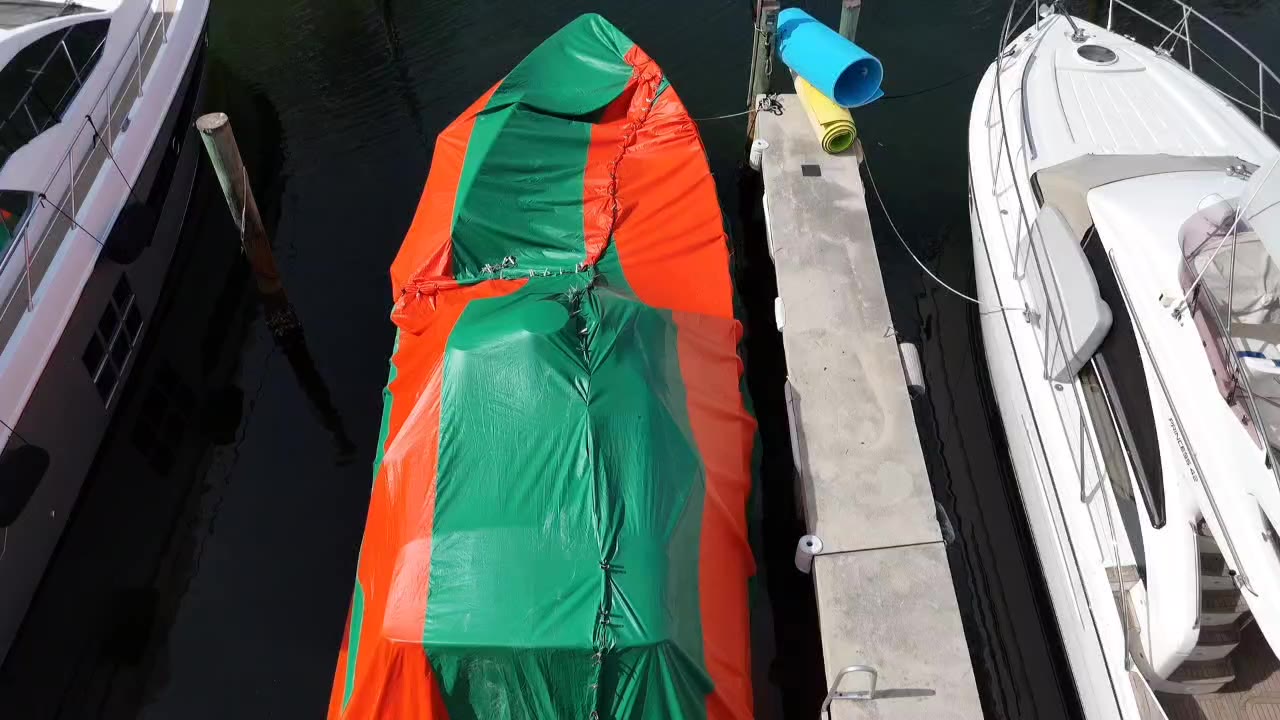 Tented boat between two yachts