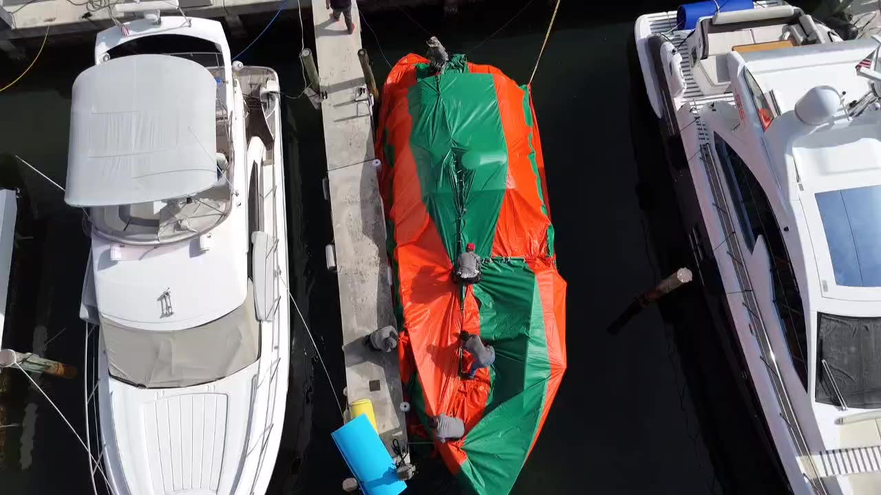 Boat fully tented in its slip, seen from above