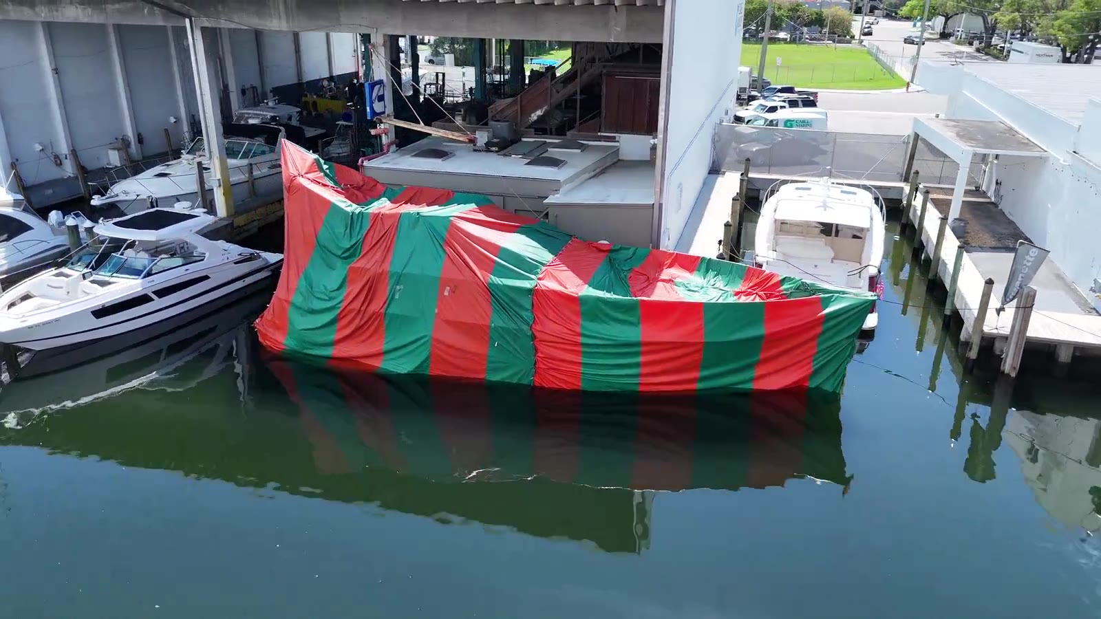 Tented boat docked next to a building